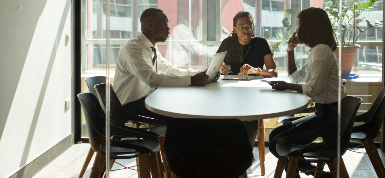 people sat around a desk at work